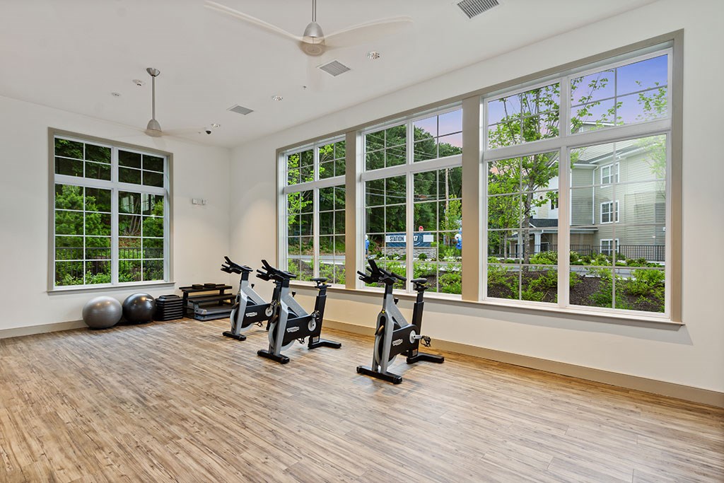 Fitness studio with wood flooring, mats and spin bikes