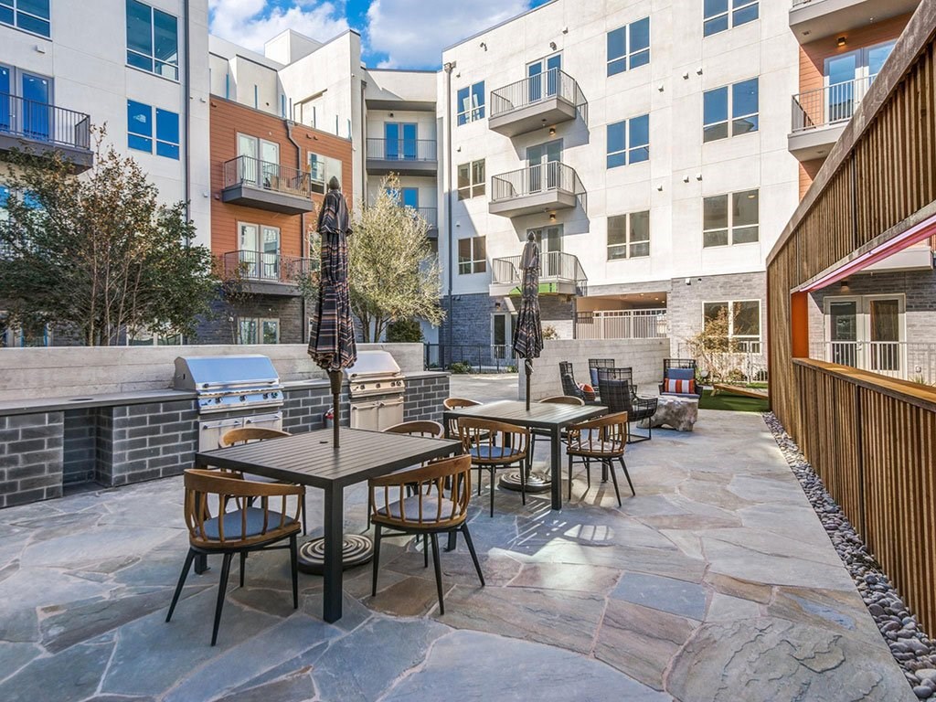 picnic and lounging areas around the pool with access to grilling stations