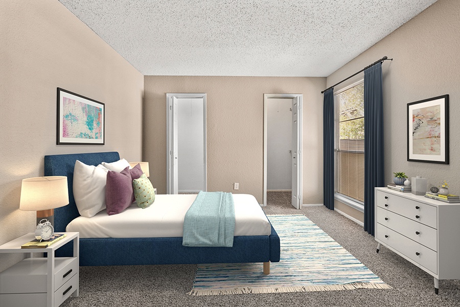 Generously proportioned one-bedroom space with carpet flooring and a strategically placed window at the head of the bed, offering a well-lit and comfortable living area.