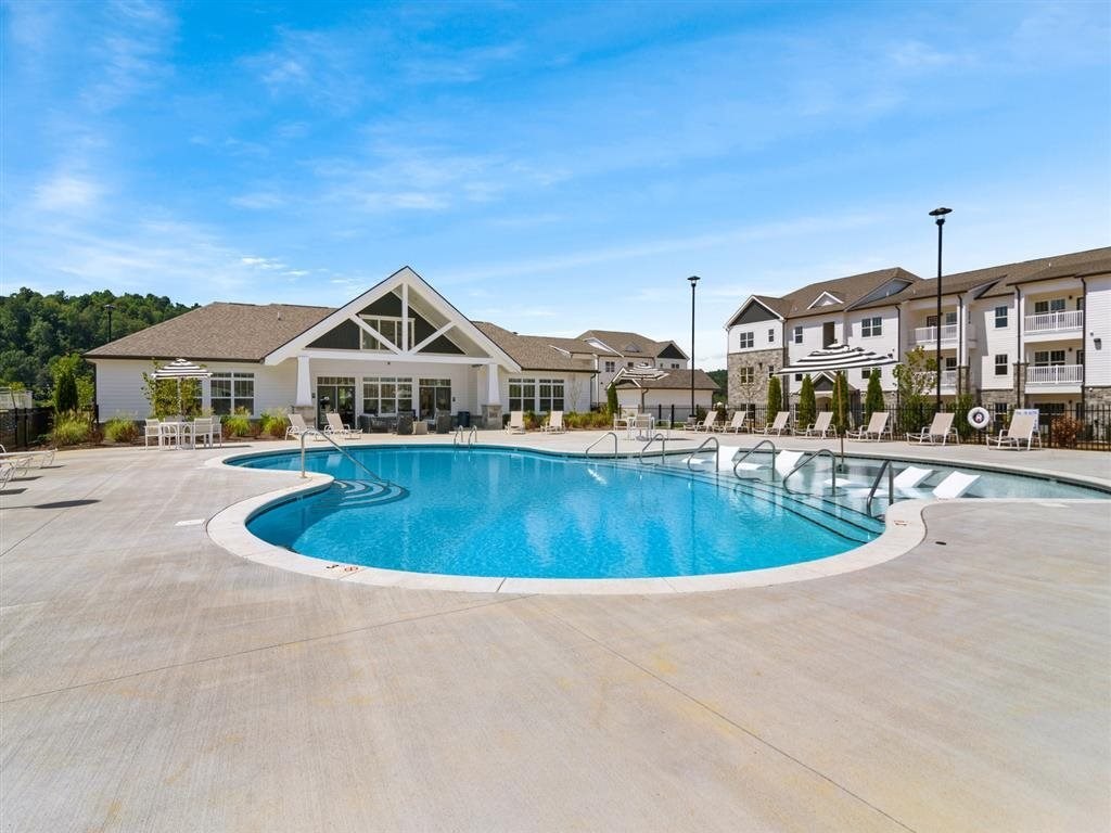 a swimming pool with apartments in the background