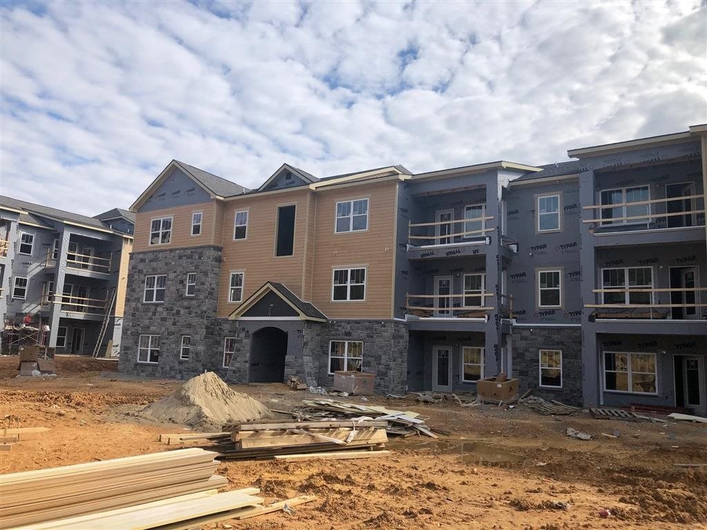 a large building under construction with wood and dirt