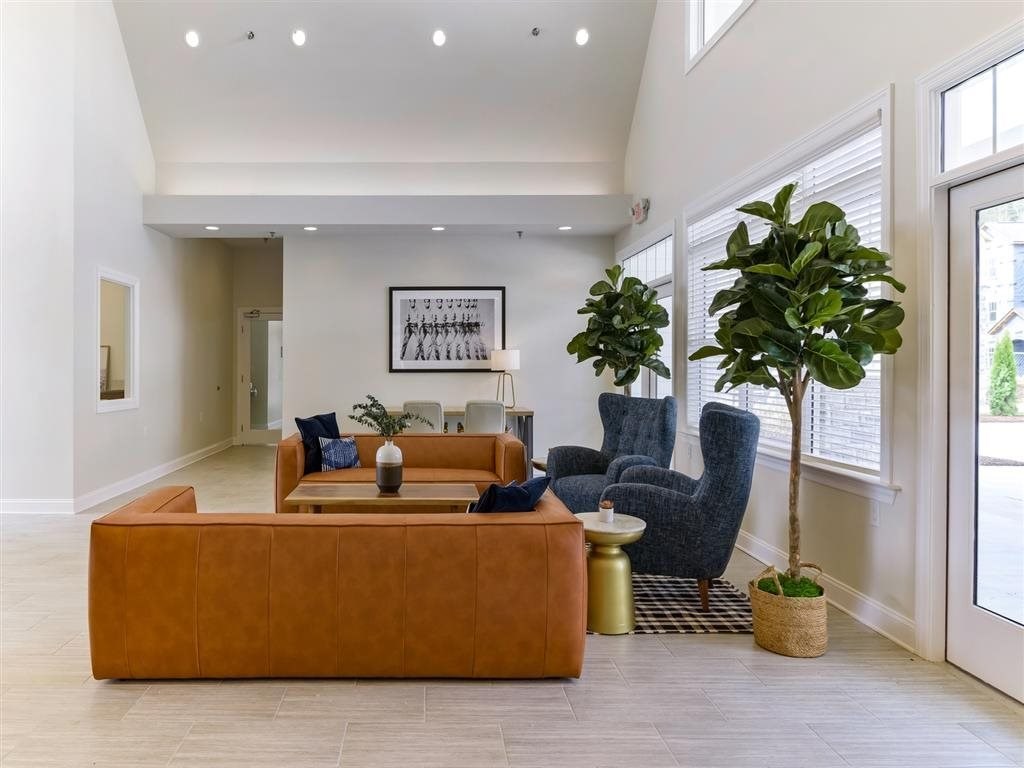 the living room has large windows and a large couch