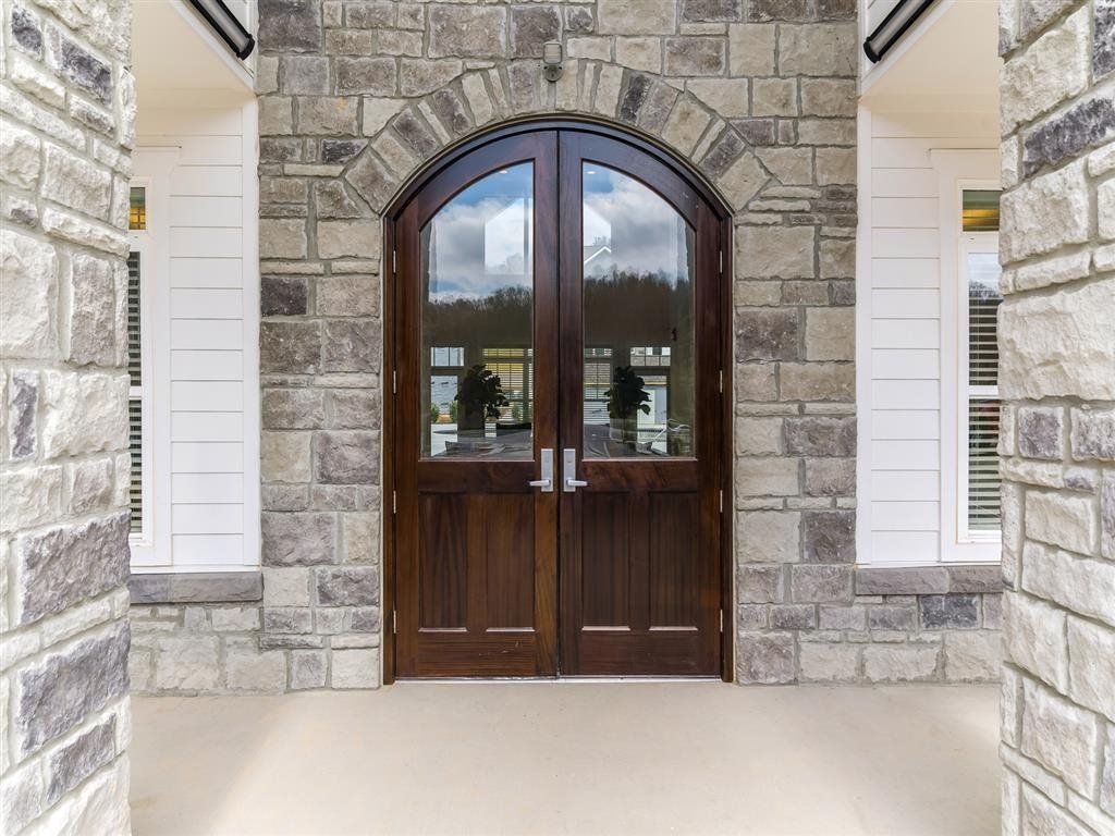 a pair of wooden doors on a stone building