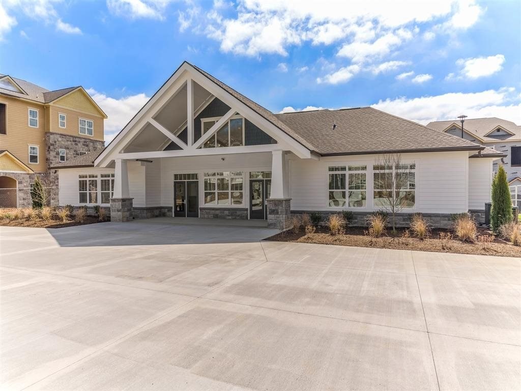 a large building with a driveway in front of it