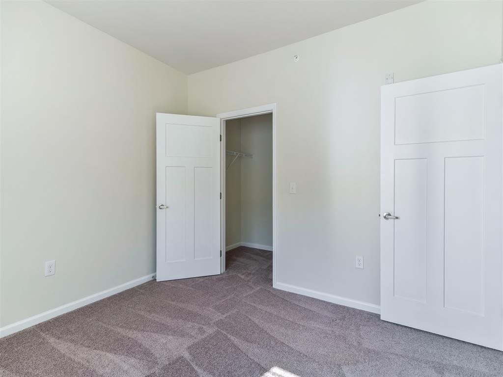 a bedroom with two closets and a door to a closet