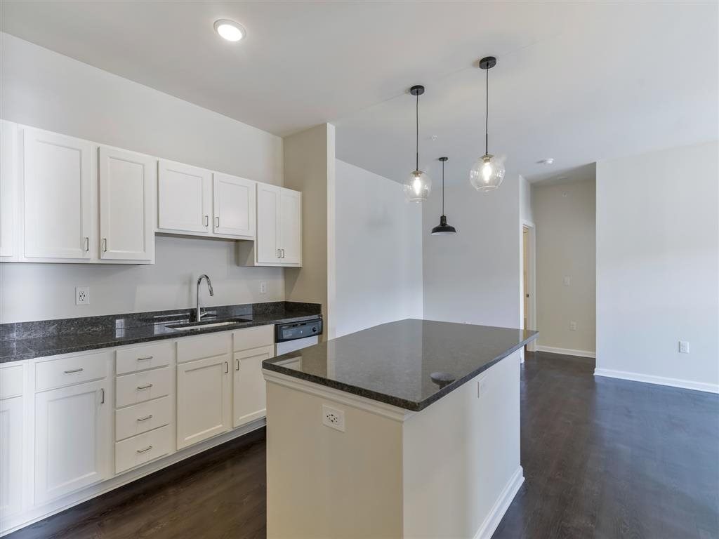 a kitchen with white cabinets and a counter top