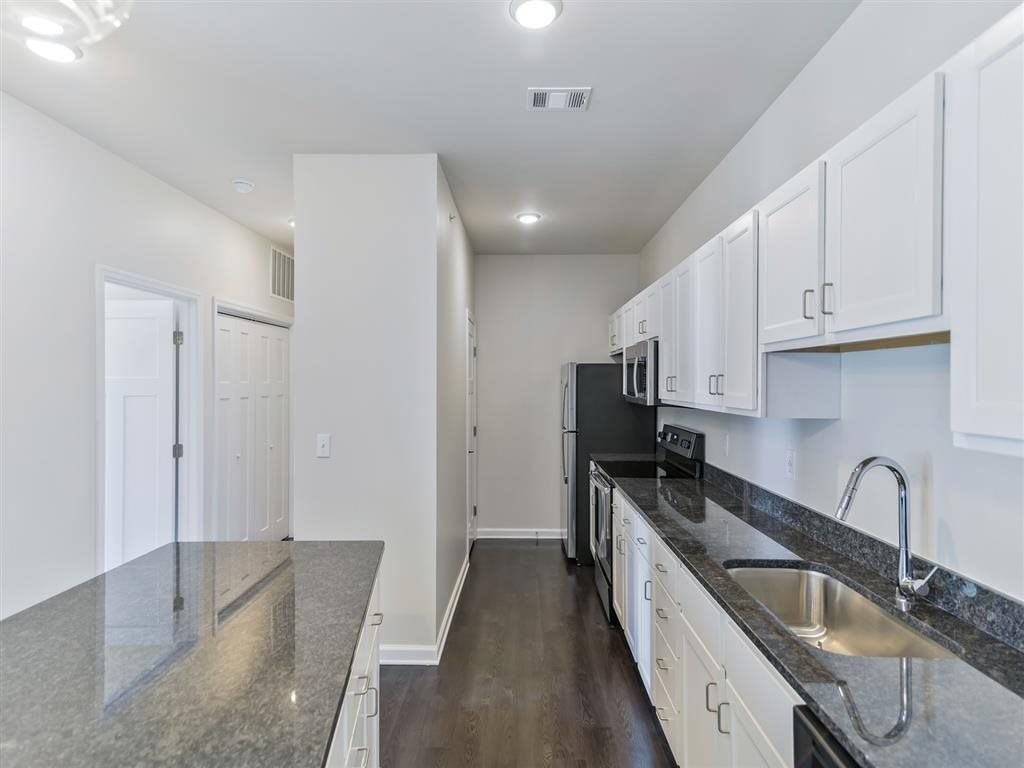 a kitchen with a counter top and a sink