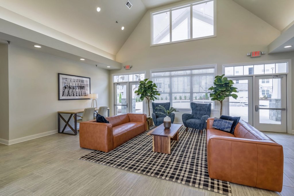 Ashland Farms Resident Clubhouse with Couch Seating, Modern Decor, and View of Pool Area
