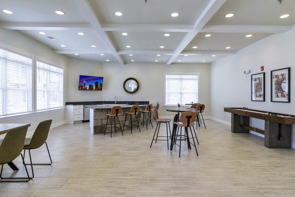Ashland Farms Resident Clubhouse Game Room with Table Seating, TV, and Shuffleboard