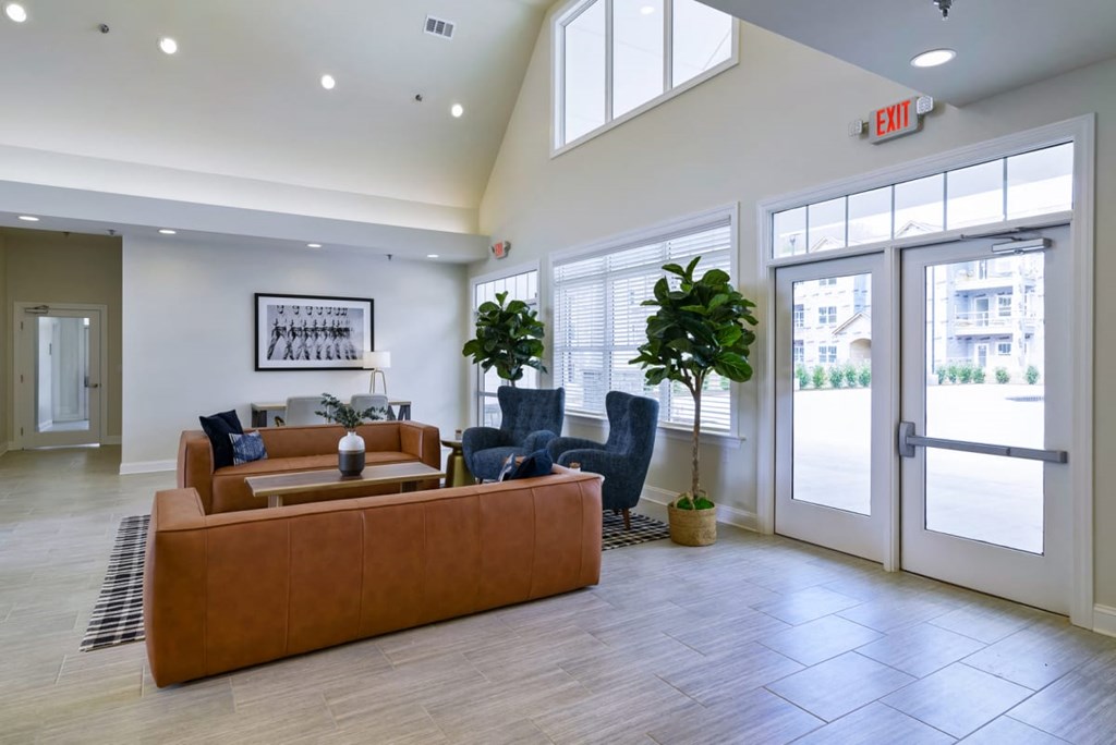 Ashland Farms Resident Clubhouse with Couch Seating, Modern Decor, and View of Pool Area