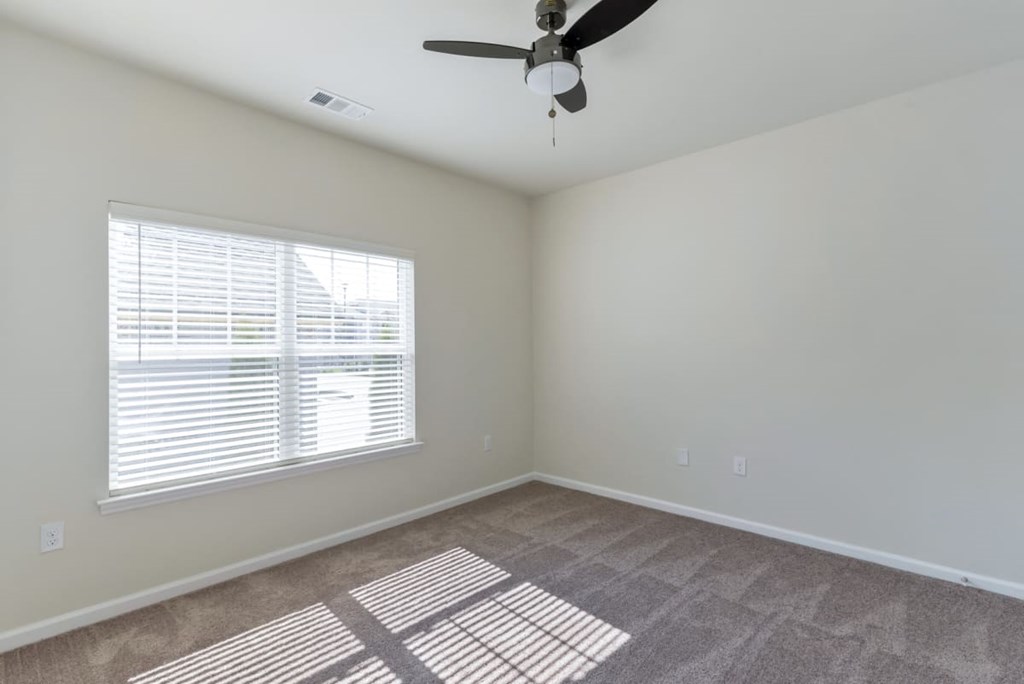 Ashland Farms Bedroom with Carpet Floors, Ceiling Fan, and Large Window