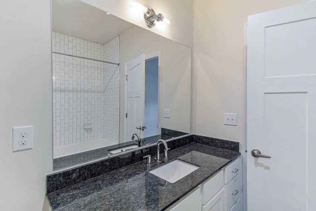 Ashland Farms Bathroom with Granite Counters, Single Sink Vanity, and White Cabinetry
