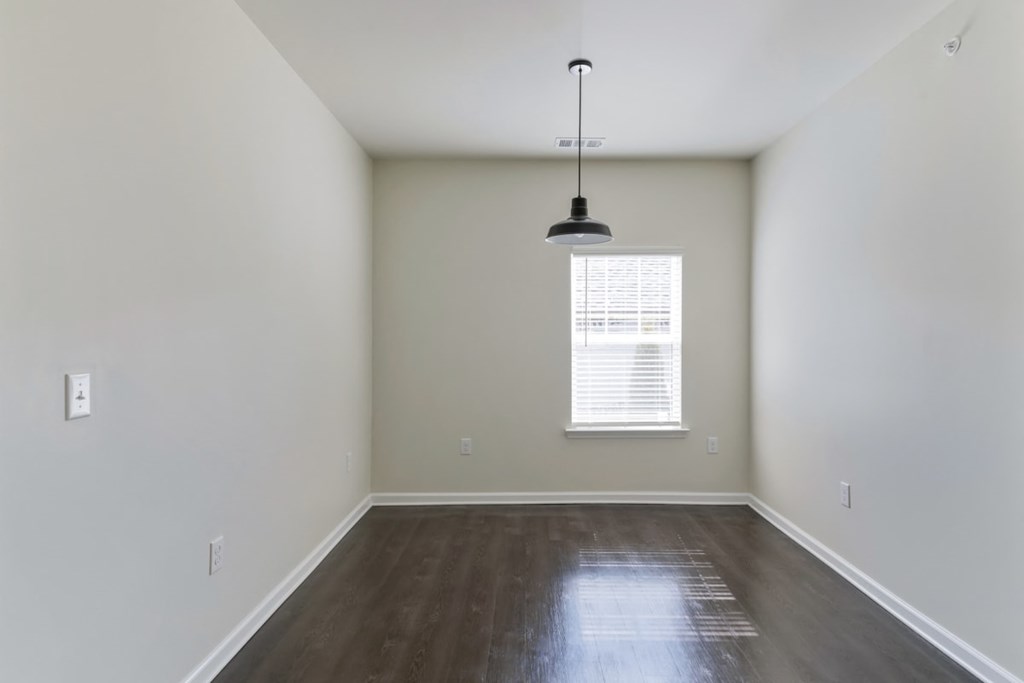 Ashland Farms Bedroom with Wood-Style Flooring, Modern Light Fixture, and Window