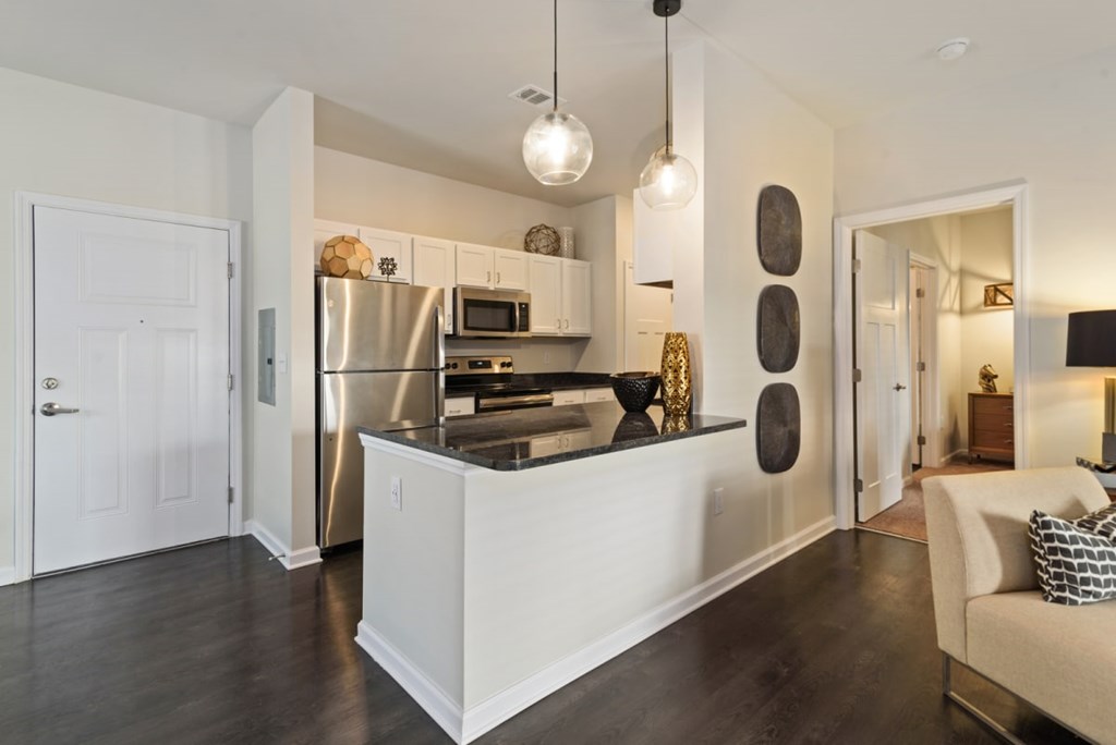 Ashland Farms Apartments Kitchen with Modern Lighting, Eat-in Counter, and Stainless Appliances