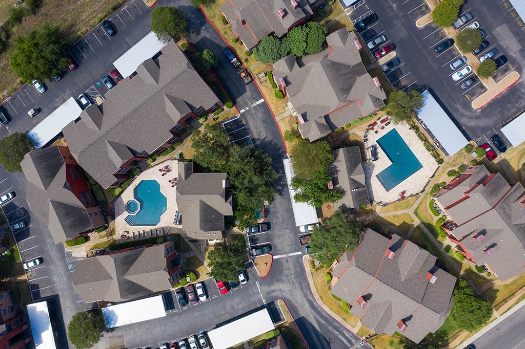 an aerial view of a neighborhood with houses and a swimming pool