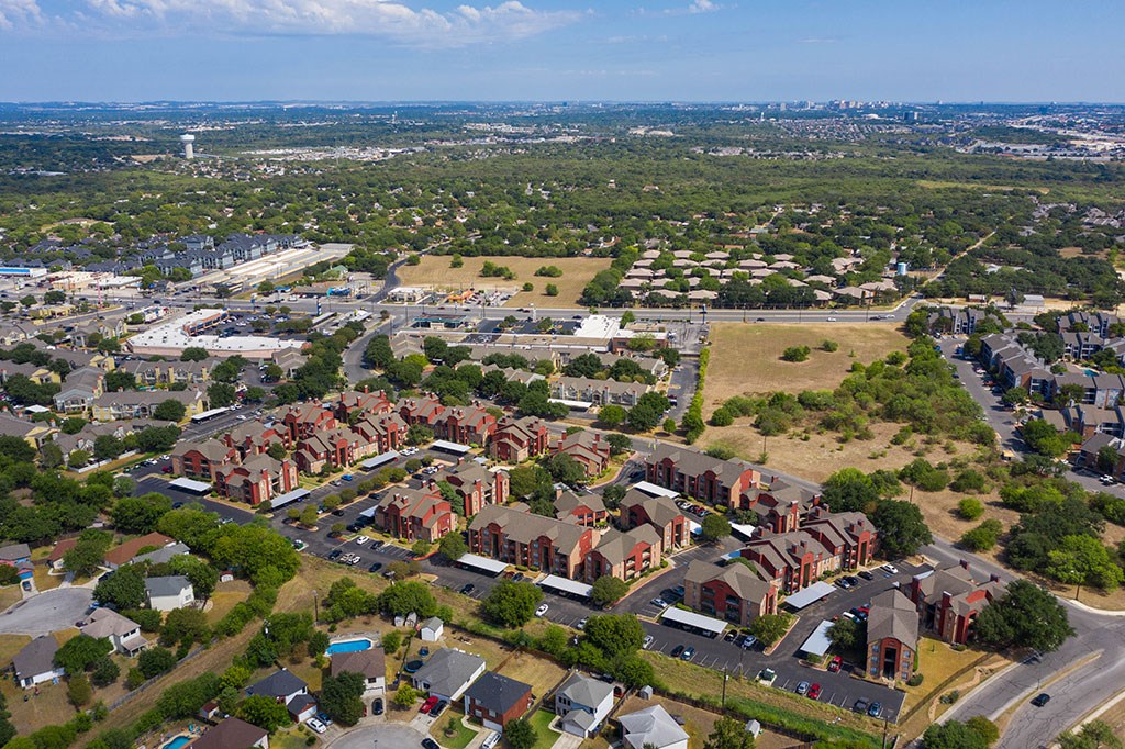 an aerial view of a neighborhood with houses and cars