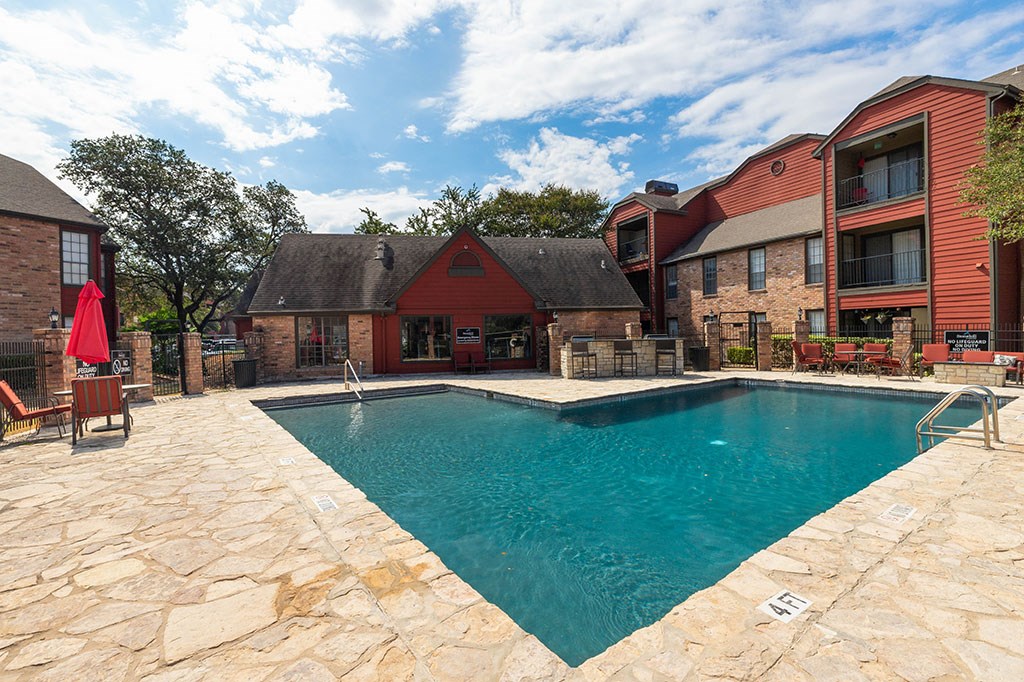 a swimming pool with a house in the background