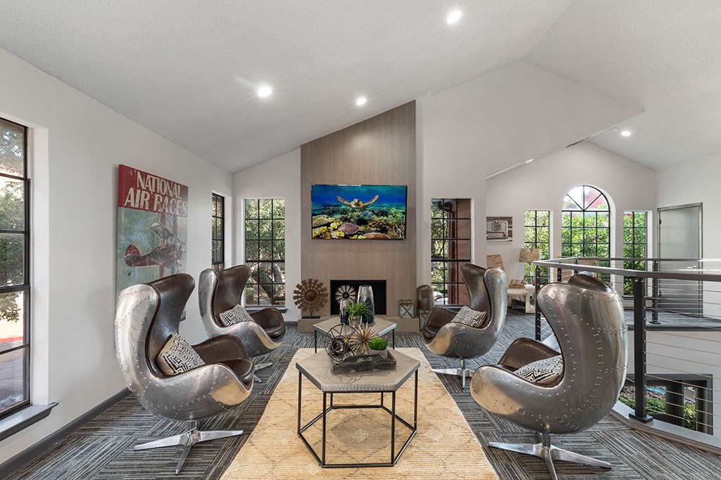 a living room with rocking chairs and a fireplace