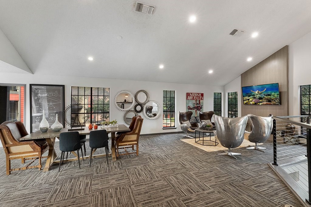 a living room with a table and chairs and a spiral staircase