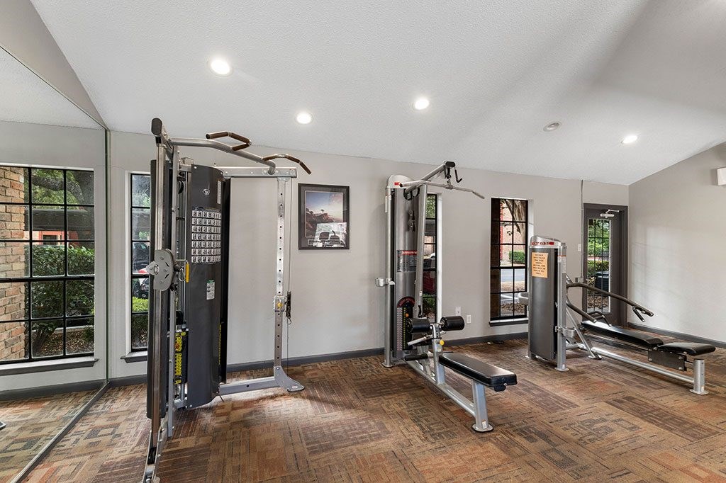 the gym has plenty of equipment and a large window