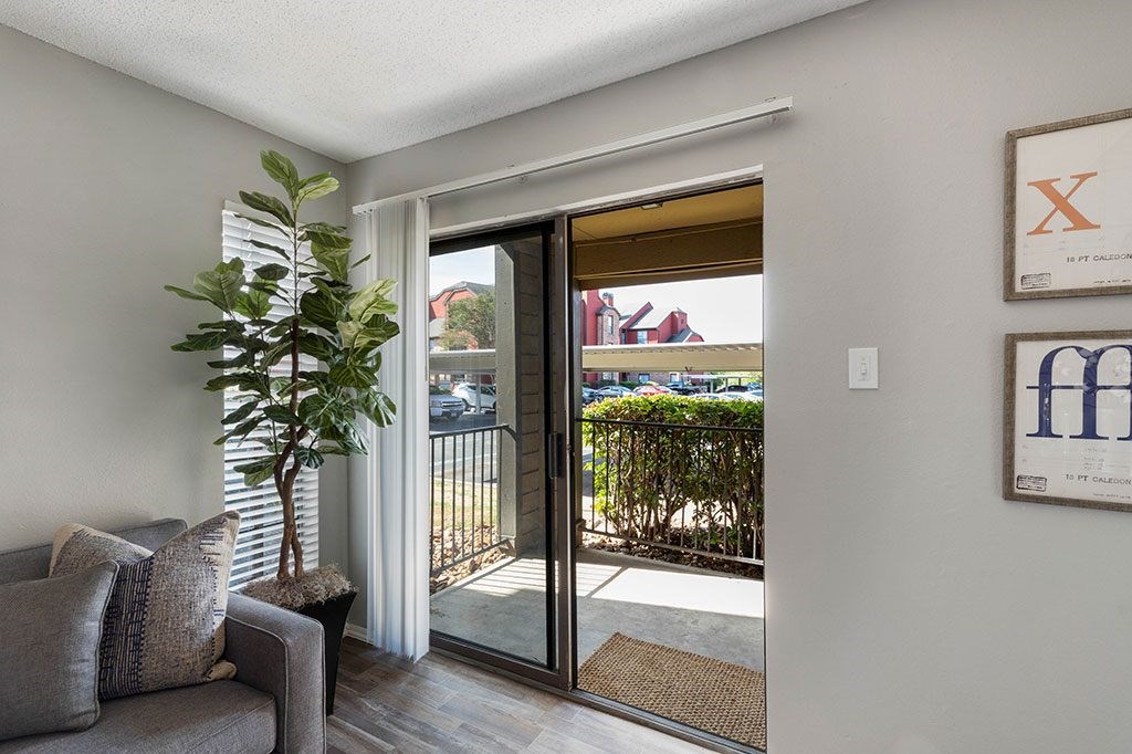 a living room with a couch and a door to a balcony