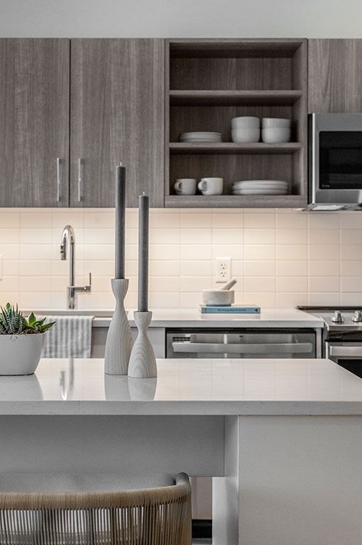 Kitchen with stainless steel appliances, two-tone kitchen cabinets and island a