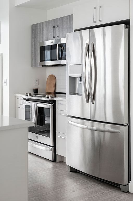 Kitchen with stainless steel appliances and two tone cabinets