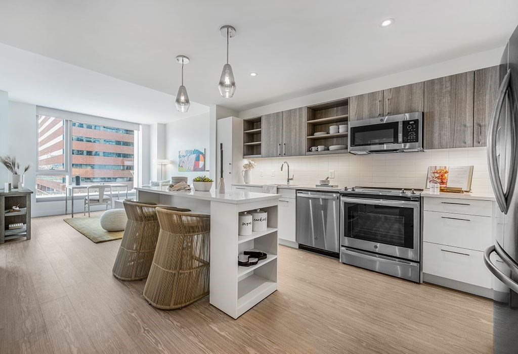 Kitchen with stainless steel appliances, two-tone kitchen cabinets with island and large windows