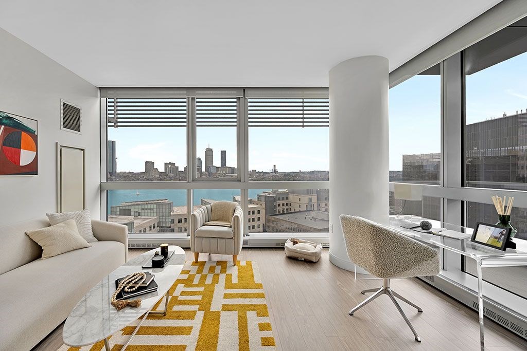 Living room with wall to wall windows and city views