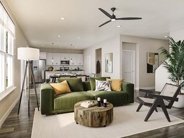 a living room filled with furniture and a ceiling fan