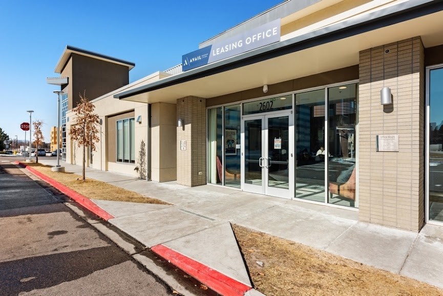 a building with glass doors and a sign that says ashing office