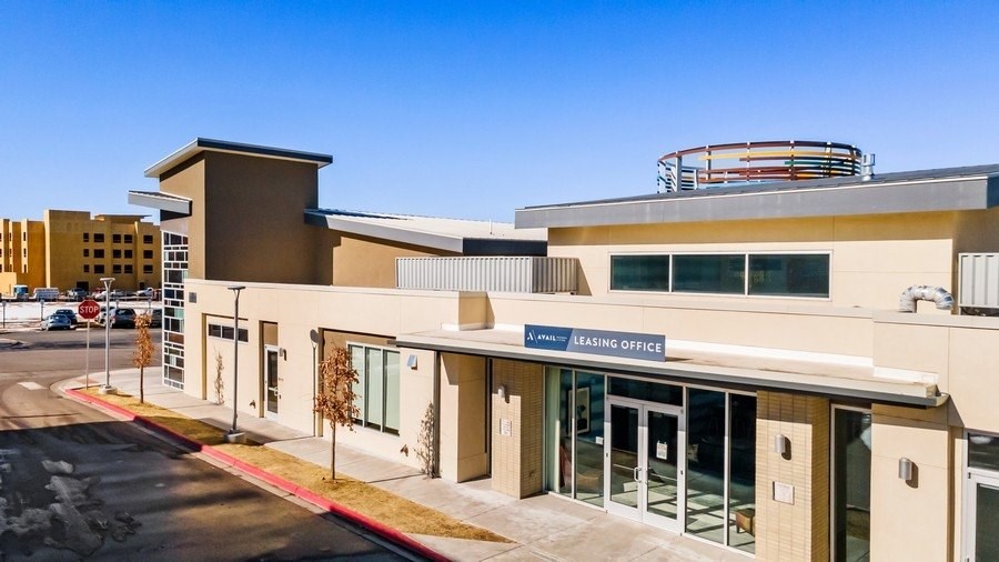 a picture of the front of a building with a clear blue sky in the background
