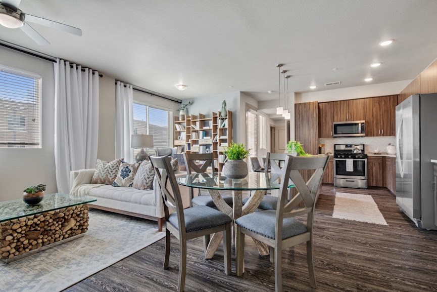 an open floor plan with a dining room table and chairs and a living room with a couch
