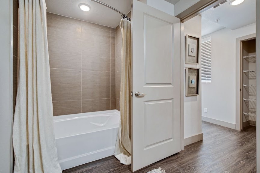 a bathroom with a shower and a bathtub