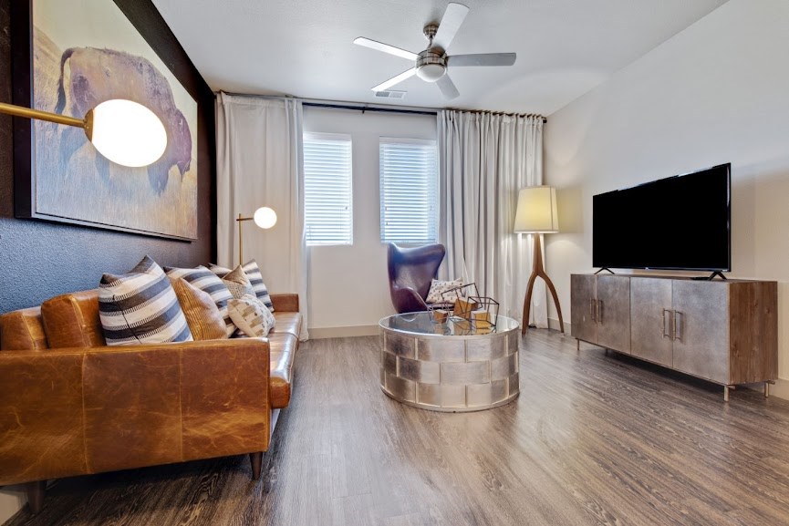 an image of a living room with hardwood flooring and a flat screen tv
