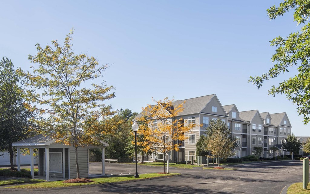 a building with a street and trees in front of it