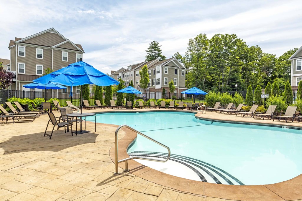 our apartments have a resort style pool with chairs and umbrellas