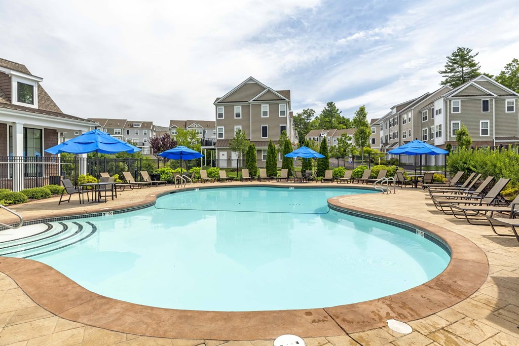 our apartments have a large pool with chairs and umbrellas