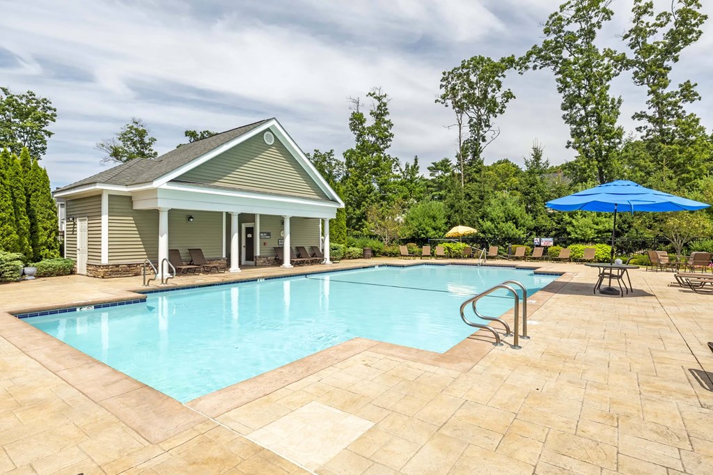 a swimming pool with a house in the background