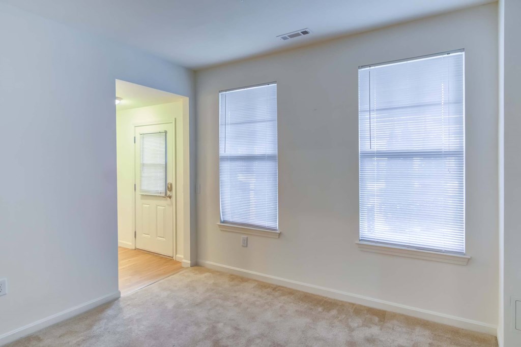 A room with a door and two windows.