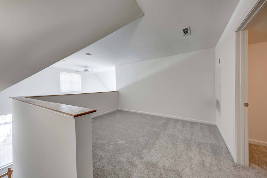 an empty attic with white walls and a counter