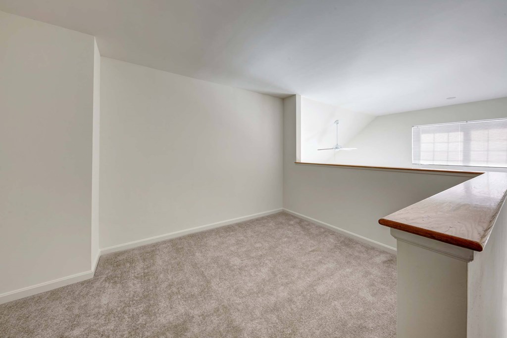 an empty room with a window and a table