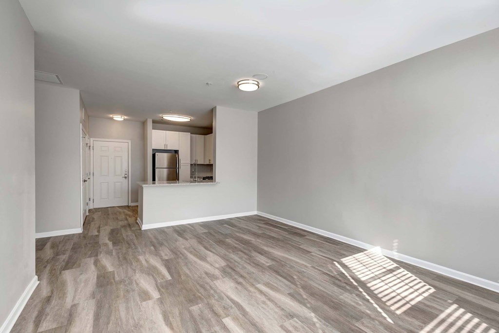an empty living room and kitchen in a new home