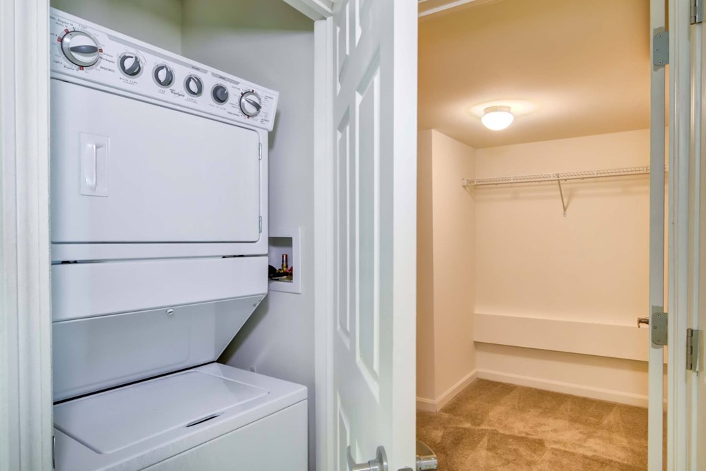 a washer and dryer in a laundry room with a closet