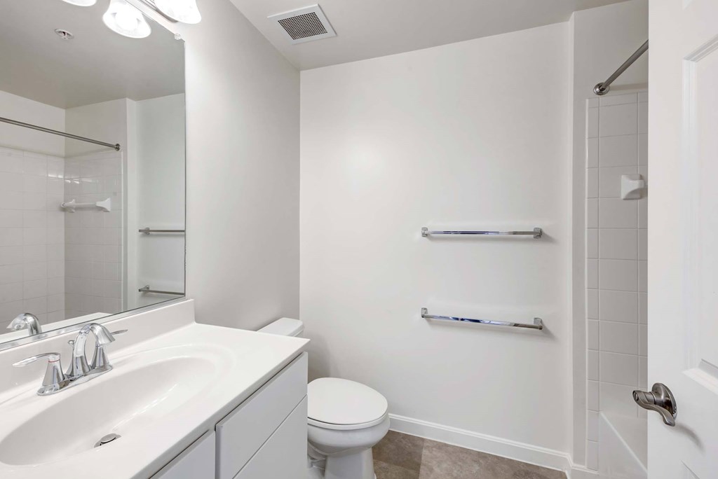 a bathroom with a sink toilet and a mirror