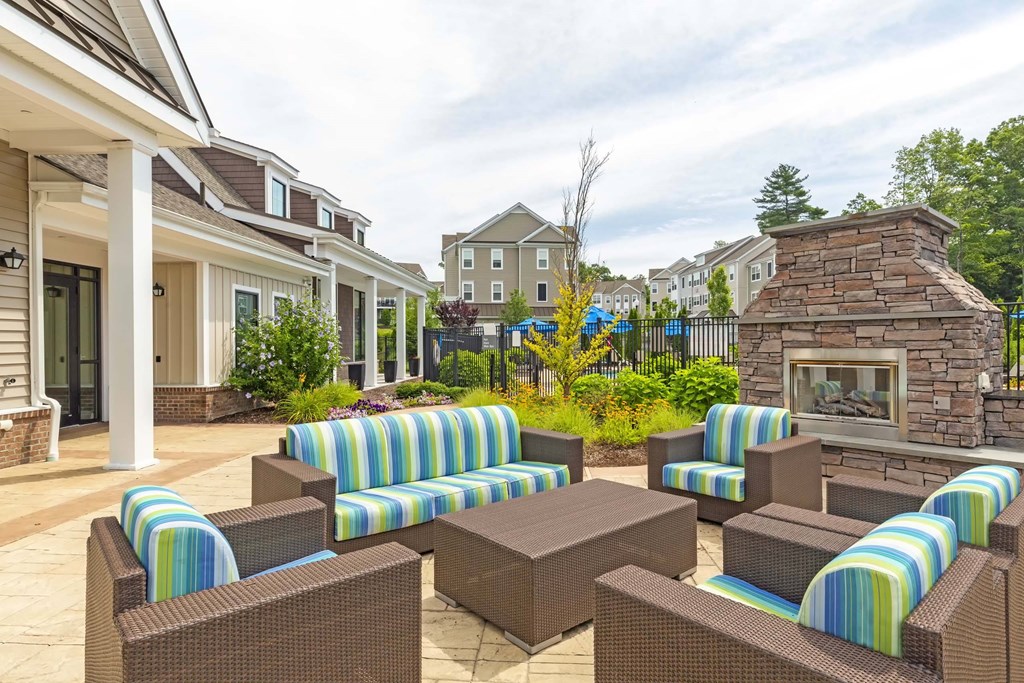 an outdoor patio with chairs and a fireplace