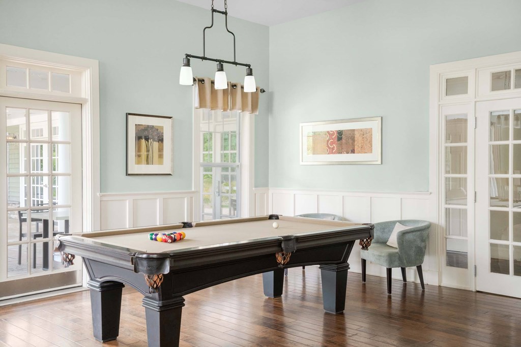 a pool table in a living room with blue walls