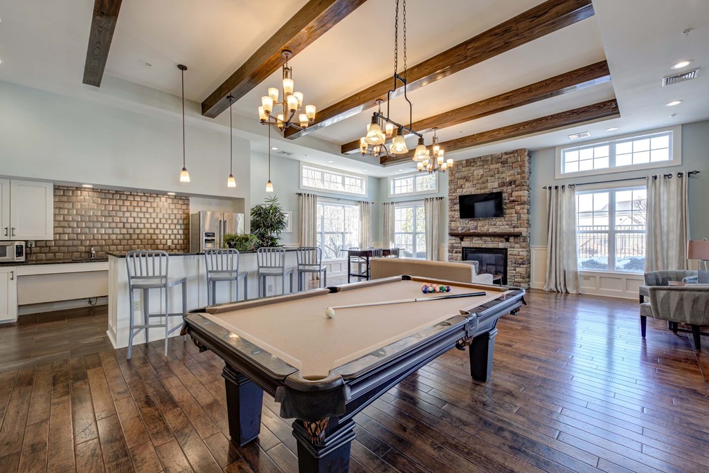 a game room with a pool table and a fireplace