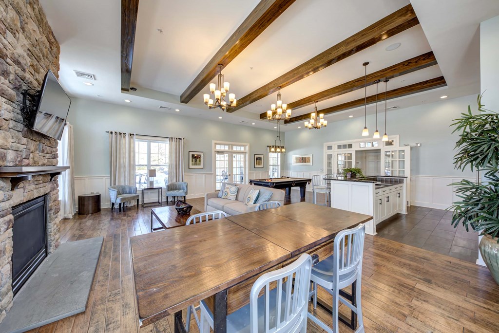 a large living room with a dining table and a kitchen