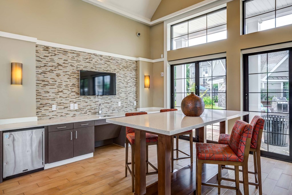 a kitchen with a center island and a table with chairs